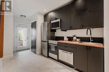 Toronto (The Beaches) apartment for rent - A modern kitchen with dark brown cabinets and stainless steel appliances.