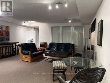 Toronto (Cabbagetown-South St. James Town) townhouse for rent - A living room with a glass table and chairs.