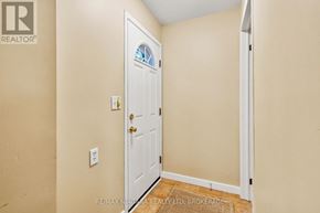 Niagara-On-The-Lake (Town) apartment for rent - A white door with a glass window is in a room with beige walls.