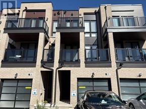 Markham (Cornell) townhouse for rent - A building with balconies and a car parked in front.