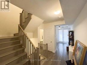 Markham (Cornell) townhouse for rent - A staircase with a wooden handrail and a white wall.