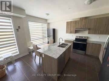 Markham (Cornell) townhouse for rent - A kitchen with a table and chairs in front of a window with blinds.
