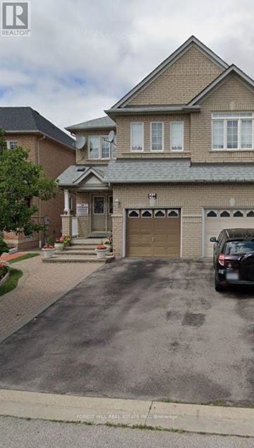 Vaughan (Vellore Village) apartment for rent - A house with a garage and a car parked in front.