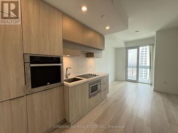 Toronto (Mount Pleasant West) condo for rent - A modern kitchen with wooden cabinets and a stainless steel oven.