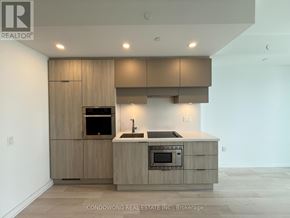 Toronto (Mount Pleasant West) condo for rent - A modern kitchen with wooden cabinets and a built-in oven.