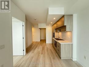 Toronto (Mount Pleasant West) condo for rent - A modern kitchen with wooden floors and white walls.