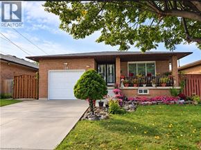 Hamilton apartment for rent - A house with a white garage door and a brown fence.