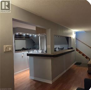 Hamilton apartment for rent - A bar area with a counter and stairs in the background.
