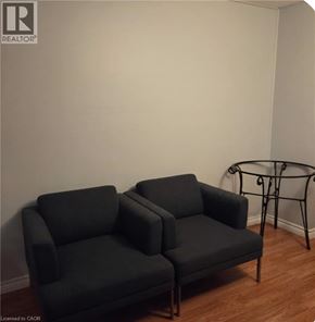 Hamilton apartment for rent - Two grey couches in a room with a glass table.