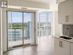 Toronto (Willowdale West) condo for rent - A kitchen with a view of the city through the window.