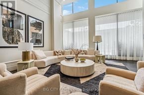 Toronto (Thorncliffe Park) condo for rent - A living room with a large window and a white sofa.