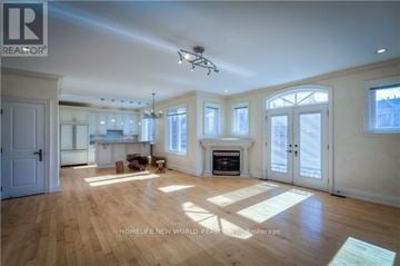 Toronto (Newtonbrook East) apartment for rent - A spacious living room with wooden floors and a fireplace.