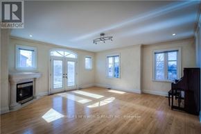 Toronto (Newtonbrook East) apartment for rent - A spacious room with a fireplace, a piano, and a large window.