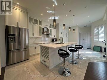 Markham (Cornell) apartment for rent - A modern kitchen with a bar stool and a refrigerator.