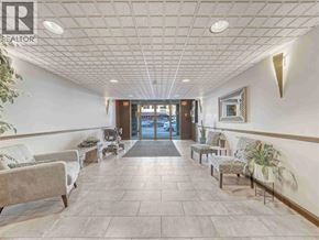 Vancouver apartment for rent - A waiting area with a tile floor and a glass door in the background.