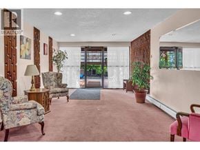 Maple Ridge apartment for rent - A living room with a pink carpet and a wooden door.