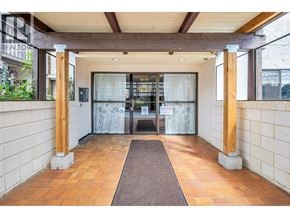 Maple Ridge apartment for rent - A hallway with a brown carpet and white walls.