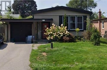 Whitby (Downtown Whitby) apartment for rent - A house with a garage and a flower bed in front.