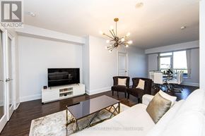 Toronto (Willowdale East) condo for rent - A living room with a white couch and a television.
