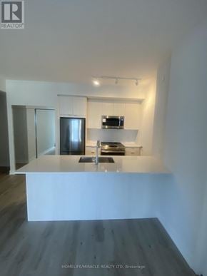 Mississauga (City Centre) condo for rent - A modern kitchen with a white countertop and stainless steel appliances.