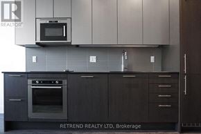 Toronto (Church-Yonge Corridor) condo for rent - A modern kitchen with a black oven and cabinets.
