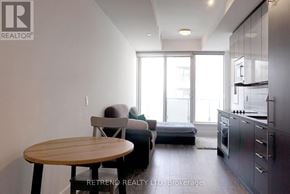 Toronto (Church-Yonge Corridor) condo for rent - A modern kitchen with a dining table and a couch.