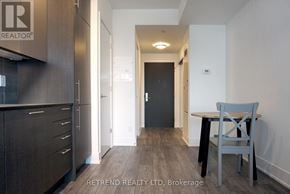 Toronto (Church-Yonge Corridor) condo for rent - A hallway with a chair and a table in the foreground and a door in the background.
