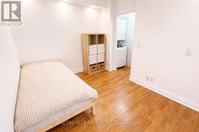 Toronto (Downsview-Roding-Cfb) condo for rent - A bedroom with a bed, wooden floor, and a small closet.