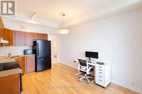 Toronto (Downsview-Roding-Cfb) condo for rent - A kitchen with wooden cabinets and a black refrigerator.