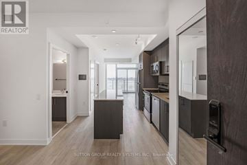 Hamilton (Riverdale) condo for rent - A modern kitchen with dark wood cabinets and a central island.