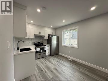 Windsor apartment for rent - A kitchen with a refrigerator, stove, and sink.