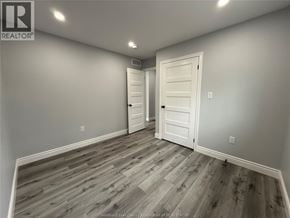Windsor apartment for rent - A room with a wooden floor and two white doors.