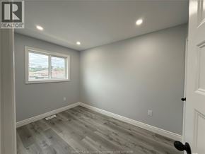 Windsor apartment for rent - A room with a window and a wooden floor.