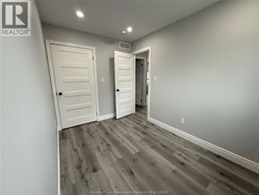 Windsor apartment for rent - A hallway with two doors and a wooden floor.