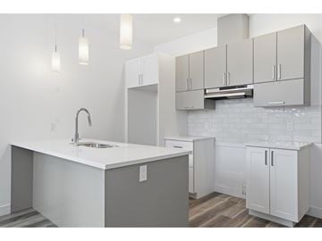 Gatineau (Aylmer) condo for rent - A kitchen with white cabinets and a white countertop.