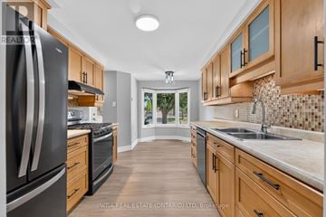 London North (North I) apartment for rent - A kitchen with wooden cabinets and a black refrigerator.