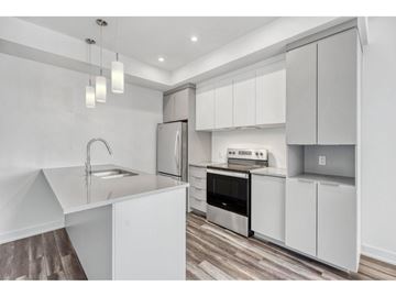 Gatineau (Aylmer) apartment for rent - A modern kitchen with white cabinets and stainless steel appliances.