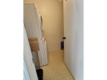 Gatineau (Aylmer) apartment for rent - A white refrigerator is in a kitchen with a black trash can.