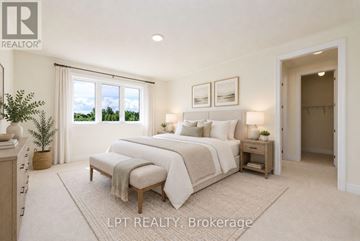 Georgina (Keswick North) apartment for rent - A bedroom with a large bed and a window overlooking a green landscape.
