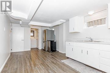 Toronto (Islington-City Centre West) apartment for rent - A kitchen with white cabinets and a black fridge.