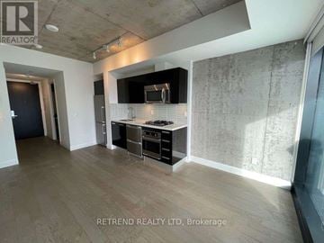 Toronto (Waterfront Communities) condo for rent - A spacious kitchen with a modern design featuring a stove, oven, and microwave.