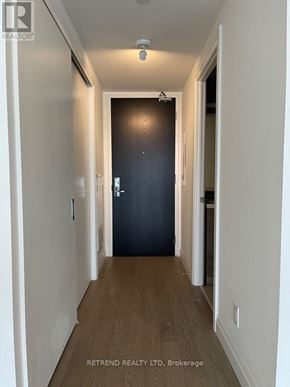 Toronto (Waterfront Communities) condo for rent - A hallway with a black door at the end.