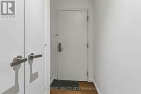 Toronto (Bay Street Corridor) condo for rent - A white door with a silver handle is in a white room.