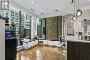 Toronto (Bay Street Corridor) condo for rent - A modern kitchen with a large island and a fish tank.