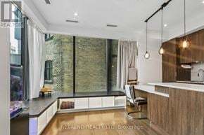 Toronto (Bay Street Corridor) condo for rent - A modern kitchen with a large window and a wooden counter.