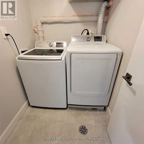 Toronto (Englemount-Lawrence) apartment for rent - A white washer and dryer in a small laundry room.