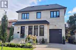 Toronto (Englemount-Lawrence) apartment for rent - A two-story house with a black garage door is for sale.