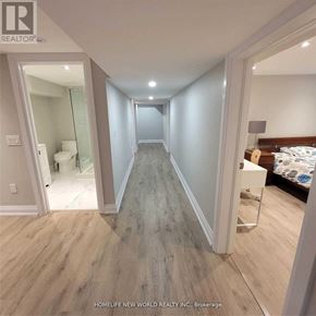 Toronto (Englemount-Lawrence) apartment for rent - A long hallway with wood flooring and white walls.