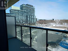 Toronto (Waterfront Communities) condo for rent - A balcony with a glass railing overlooking a construction site.