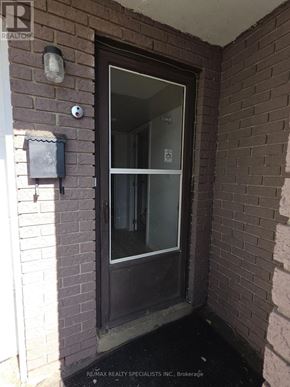 Brampton (Madoc) apartment for rent - A glass door is in a brick wall.
